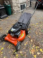 Full lawn mower left front view showing deck, wheels and handle