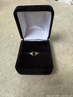 Ring in open black velvet box showing full view