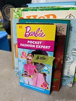 Front view showing Barbie Pocket Fashion Expert and other books behind