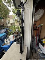 Full view of folded Manfrotto 420B stand leaning against wall