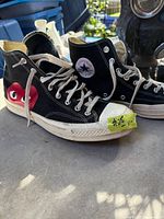 Side view of both shoes showing heart graphic and Converse logo