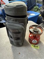MSR stove attached to red IsoPro canister next to green Maxpedition pouch