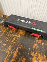 Top view of Reebok aerobic deck showing logo and risers