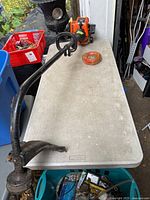 Full view of Remington Rustler RM2530 string trimmer on table with roll of trimmer line