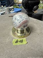 Baseball with signatures and Blue Jays logo on stand