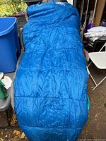 Full view of blue sleeping bag laid out