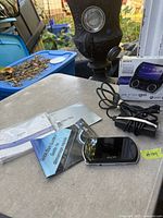 Console, manuals, software disc, power adapter and box displayed on table