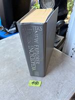 Spine view of Webster's New Explorer Desk Encyclopedia showing title and overall condition