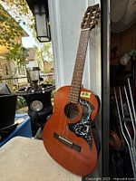 Full view of Yamaha G-40 guitar leaning against wall