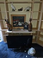 Overall view showing cat statues, geese, small figurines, framed print and concrete lion head