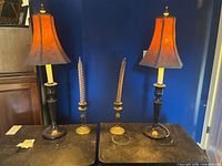 Full view of both lamps and candlesticks on tabletop