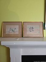 Both framed silk artworks on mantel