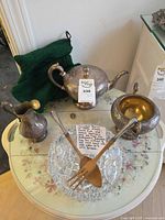 Overview showing silver tea set, crystal bowl, serving utensils