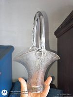 Side view of frosted pressed glass basket vase showing handle, body and foot