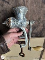 Front view of metal meat grinder showing SIF mark and Made in England text