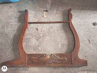 Full view of oak washstand harp back showing side supports, dowel, and carved panel