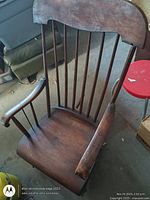 Full view of antique wooden rocking chair showing back, seat, arms, rockers