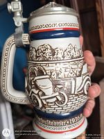 Right side of stein showing Stanley Steamer 1936 relief scene