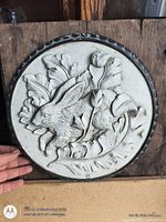 Front view of round cement plaque showing rabbit relief and edge detail