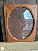 Front view of hardwood square frame with oval glass, showing broken glass bottom edge and backing board
