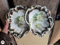 Top view of double dish showing floral design, frilled rim and central handle