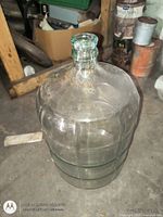 Full view of clear glass carboy showing body and neck