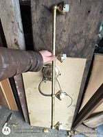 Entire brass vanity light fixture showing four sockets and overall length