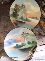 Two hand-painted scenic plates front view