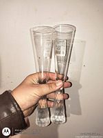 Front view of two 10-inch clear glass flutes with frosted stems and HomeSense stickers
