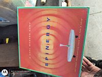 Front of Spinergy game box showing graphics and text