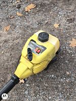 Close-up of McCulloch 317E engine housing with label and fuel cap