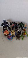 Group shot of all ten action figures and toys
