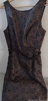 Full front view of the sleeveless brocade cocktail dress on hanger