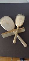 Full view of mirror, brush and comb arranged together