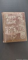 Front cover of cloth Victorian photo album titled "Our Friends"
