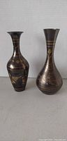 Two brass vases side by side