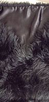 close-up of exterior faux fur and interior satin lining