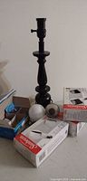 Overall lot view: lamp base, boxed bulbs, loose bulbs