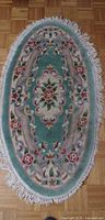 Full view of oval floral rug