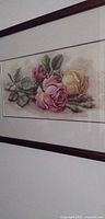 Full view of framed rose needlework