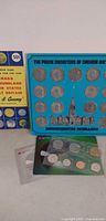 overall lot showing coin guide, medallion board, sealed coin set