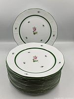 Stack of 12 Herend Vienna Rose plates with one displayed upright