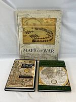 Front view of three hardcover cartography books together