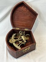 Brass sextant in open mahogany box