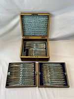 Mahogany three-tier satin lined box open showing all trays of fish service