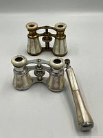 Both opera glasses, showing relative size and materials