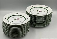 Two stacks of Herend Vienna Rose plates showing quantity and pattern