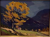 Close view of framed oil painting showing autumn tree, mountains, cabin