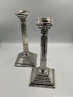 Front view of both sterling candlestick holders