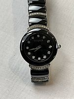 Front view of Wittnauer wristwatch showing black dial with diamond markers and bracelet
